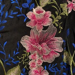 Midi length embroidered black cocktail dress.